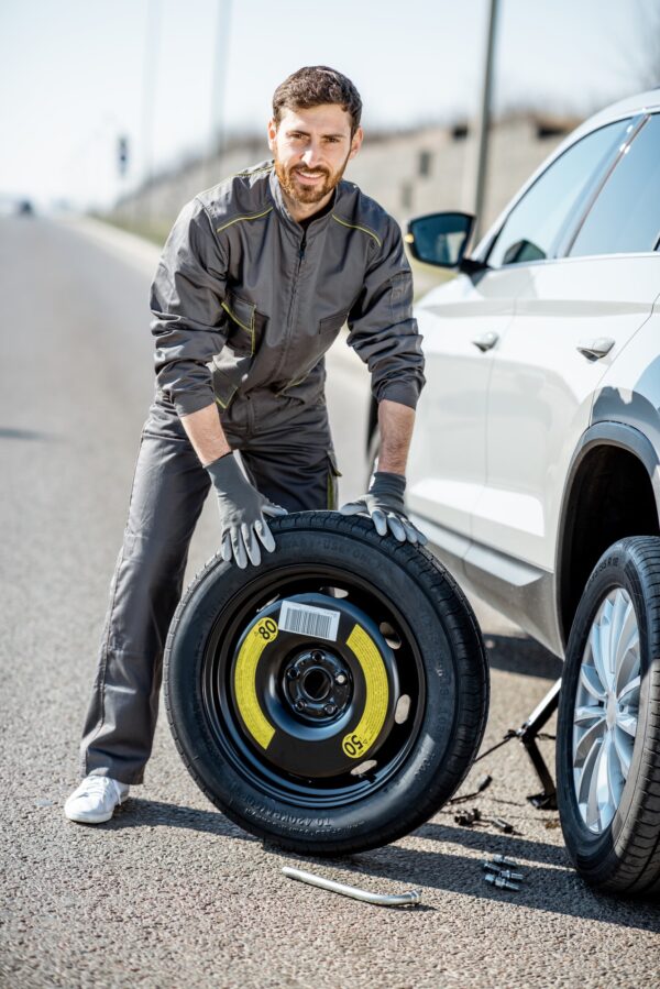 Road assistance worker near the car on the highway