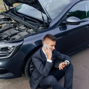 Businessman Calling for Roadside Assistance.