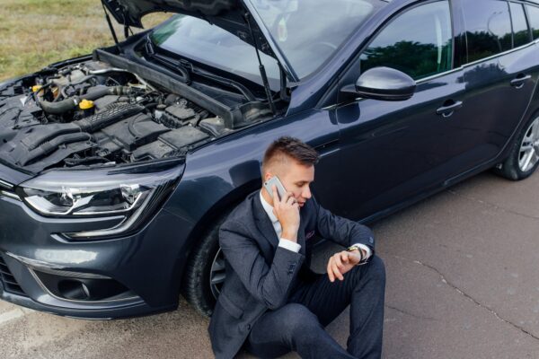 Businessman Calling for Roadside Assistance.